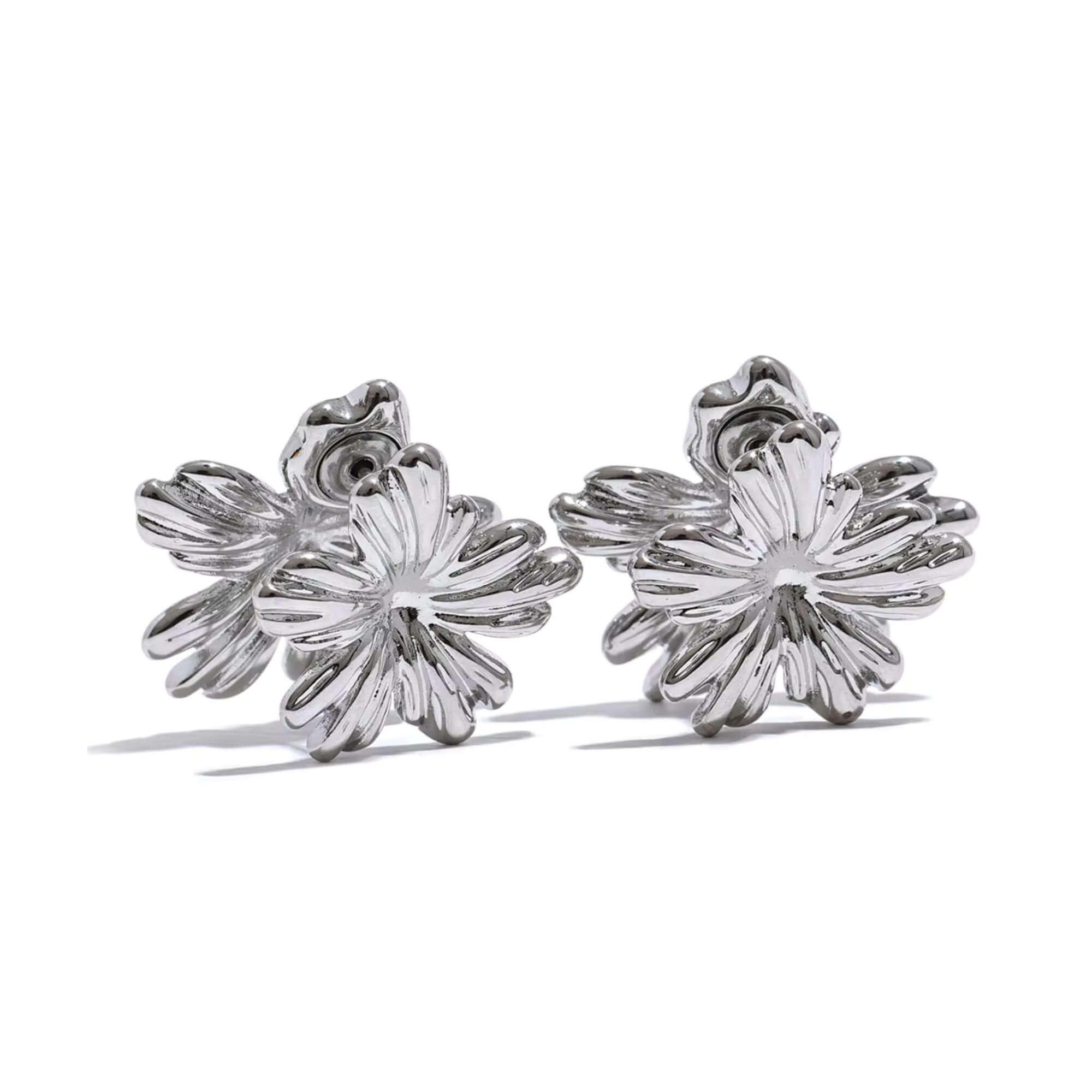Silver floral earrings on a white background