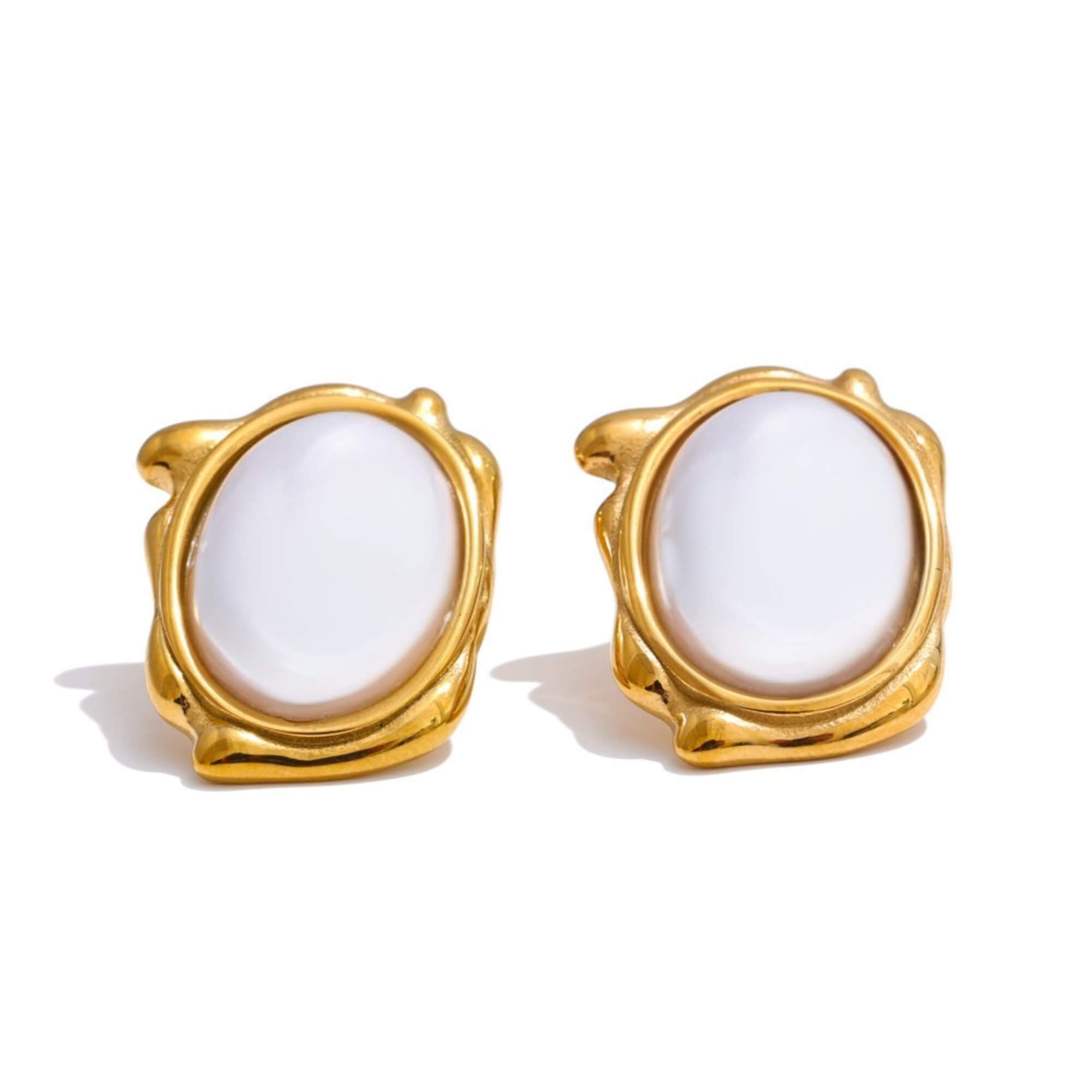 Gold-framed earrings with white stones on a white background